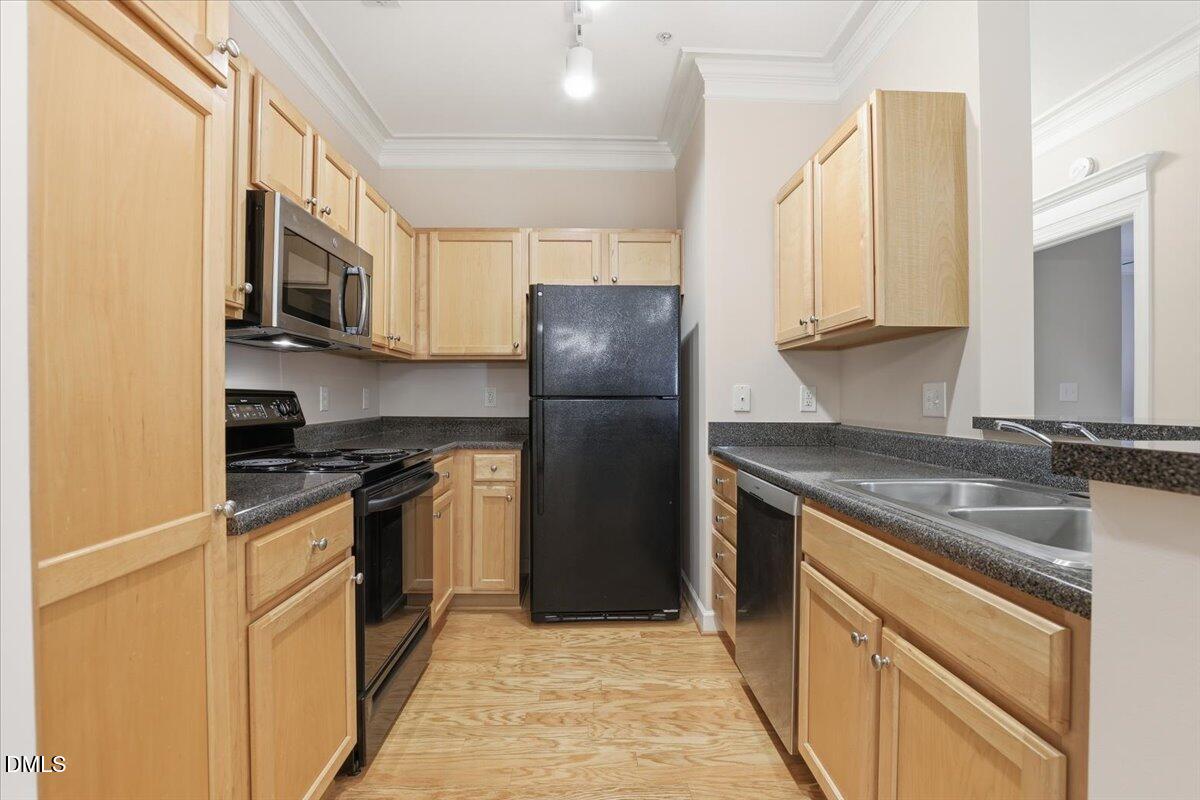 1301 Durlain Drive, Unit 208 Raleigh, NC 27614 - Photo 11 of 28 a kitchen with stainless steel appliances granite countertop a stove a refrigerator and a sink