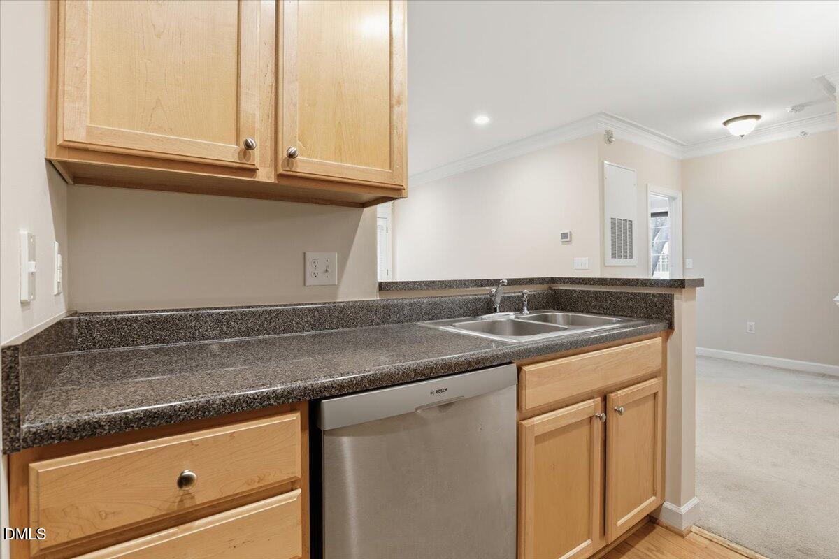 1301 Durlain Drive, Unit 208 Raleigh, NC 27614 - Photo 13 of 28 a kitchen with granite countertop a sink and a stove