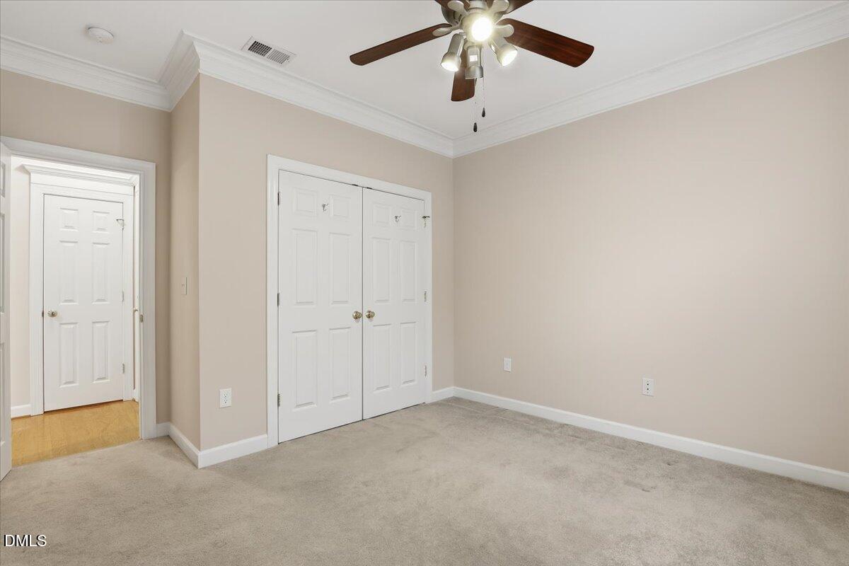 1301 Durlain Drive, Unit 208 Raleigh, NC 27614 - Photo 17 of 28 an empty room with a ceiling fan and a window