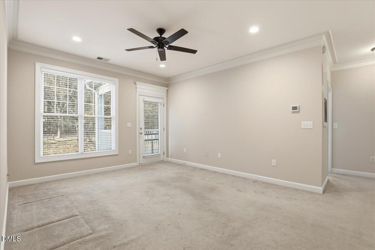 1301 Durlain Drive, Unit 208 Raleigh, NC 27614 - Photo 22 of 28 an empty room with ceiling fan and windows