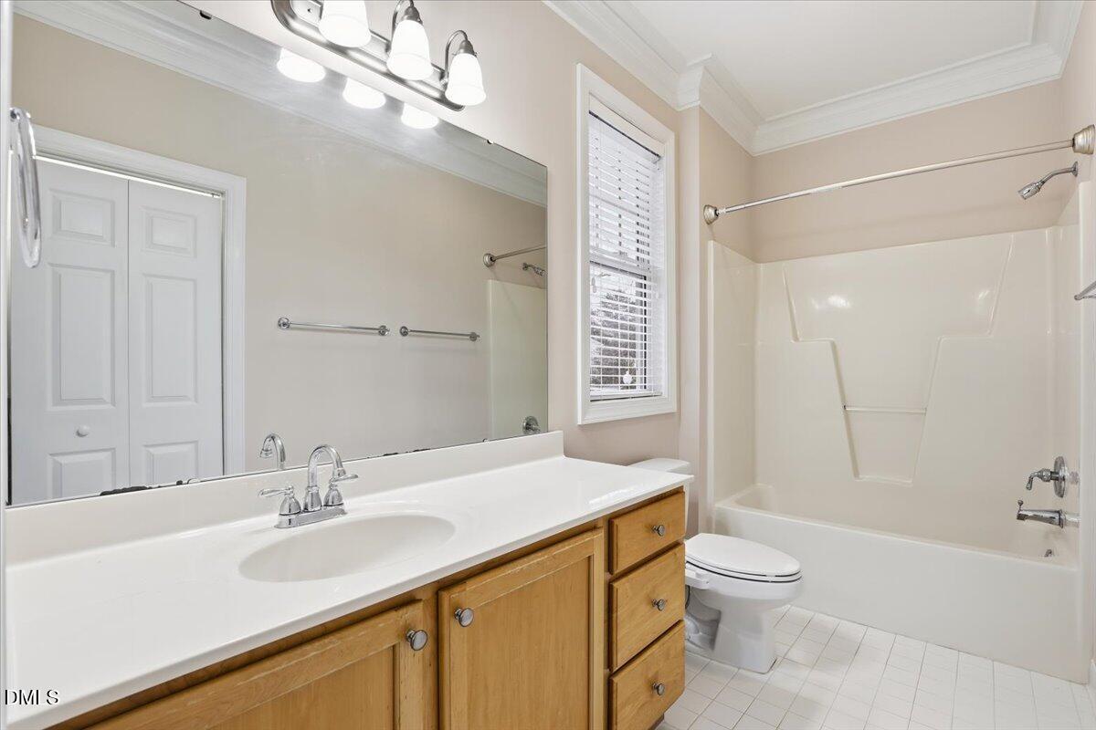 1301 Durlain Drive, Unit 208 Raleigh, NC 27614 - Photo 24 of 28 a bathroom with a sink a toilet a large mirror and shower