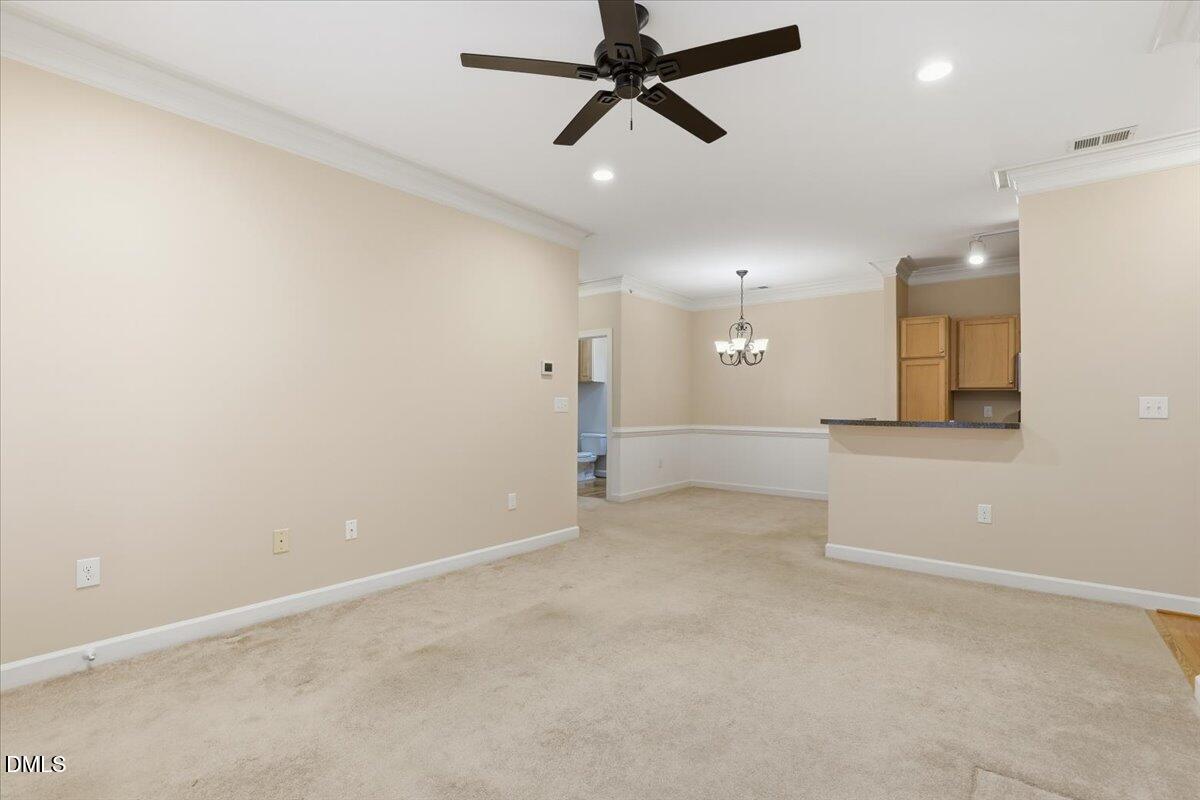 1301 Durlain Drive, Unit 208 Raleigh, NC 27614 - Photo 6 of 28 an empty room with a empty space and a ceiling fan