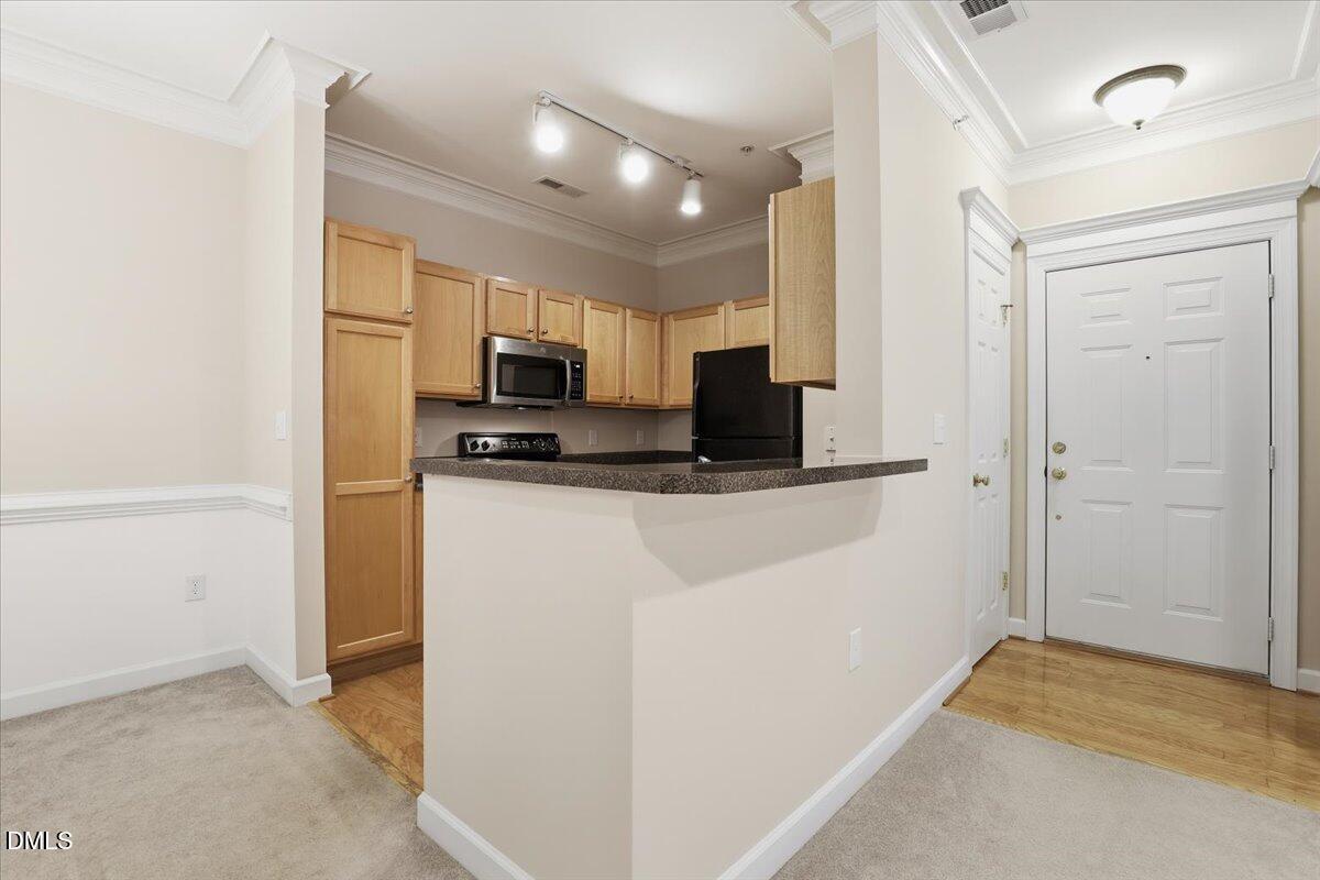 1301 Durlain Drive, Unit 208 Raleigh, NC 27614 - Photo 8 of 28 a view of a kitchen with a sink and a refrigerator