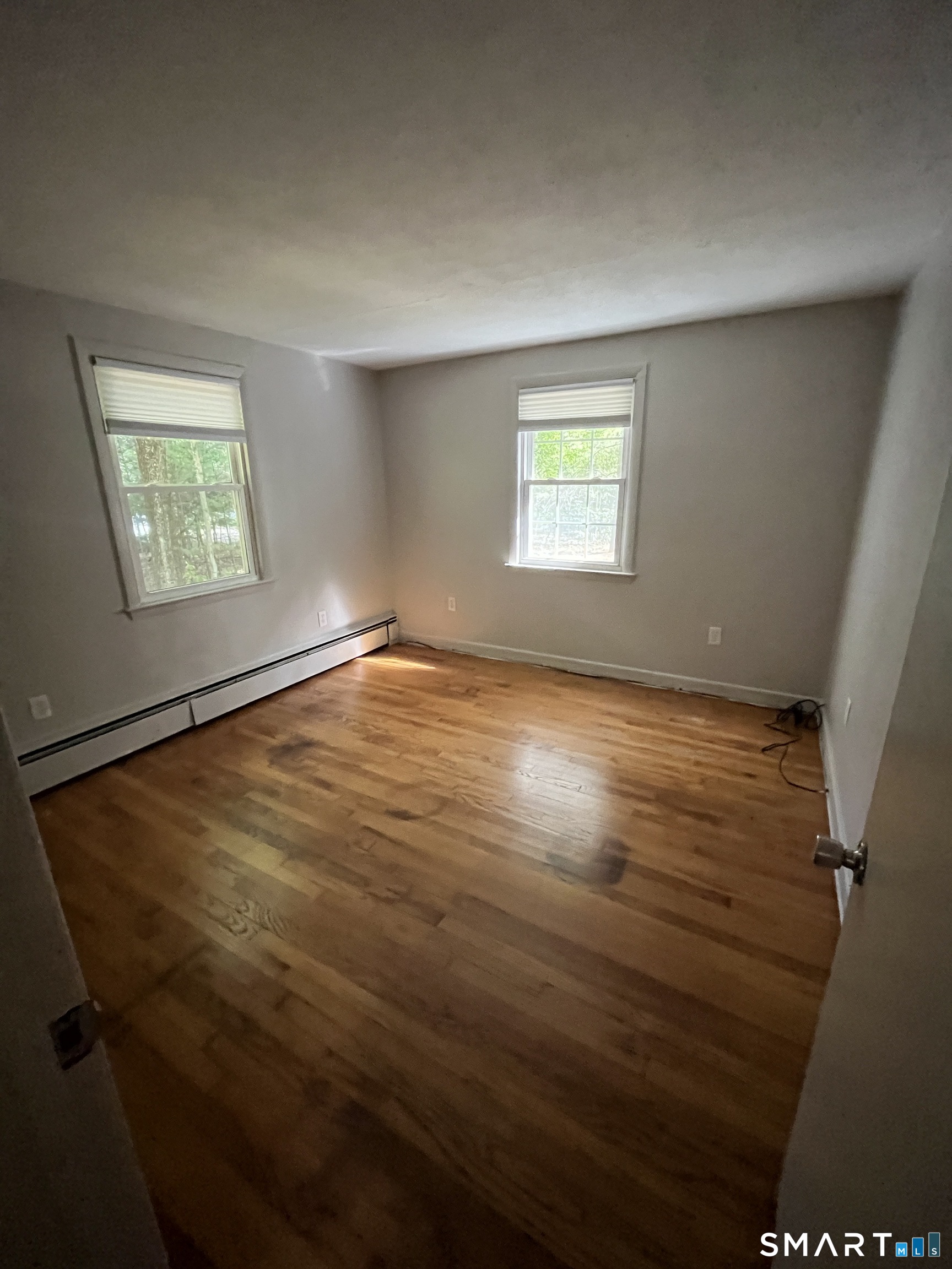 332 Richmond Road Coventry, CT 06238 - Photo 12 of 15 an empty room with wooden floor and windows