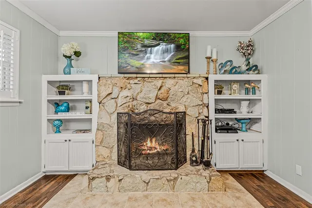 a living room with a fireplace and a painting on the wall