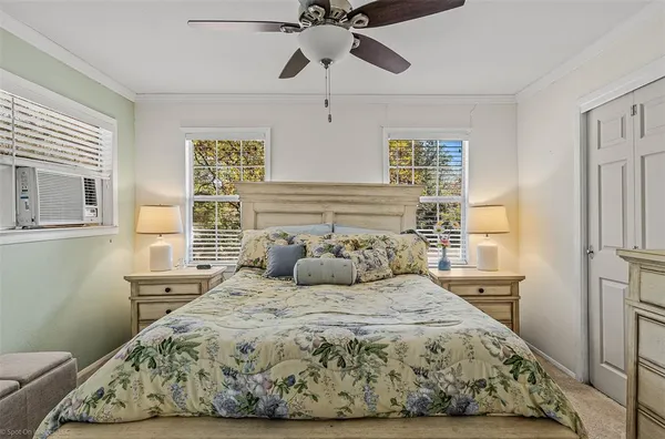 a bedroom with a large bed and a window