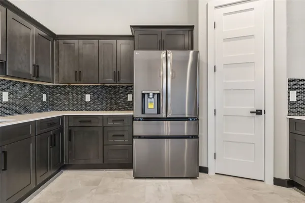 a kitchen with a refrigerator and cabinets