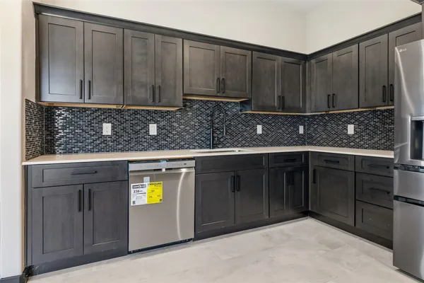 a kitchen with stainless steel appliances granite countertop a cabinets and a stove top oven