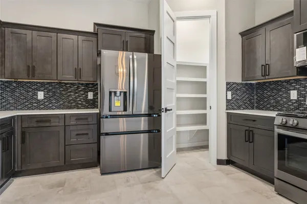 a kitchen with stainless steel appliances a refrigerator and cabinets