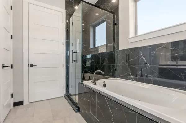 a bathroom with a bathtub and shower