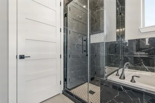 a bathroom with a bathtub and a shower