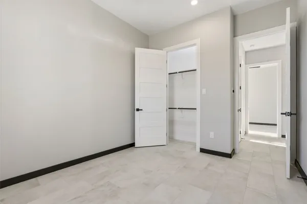 a view of an empty room with a fireplace and a window