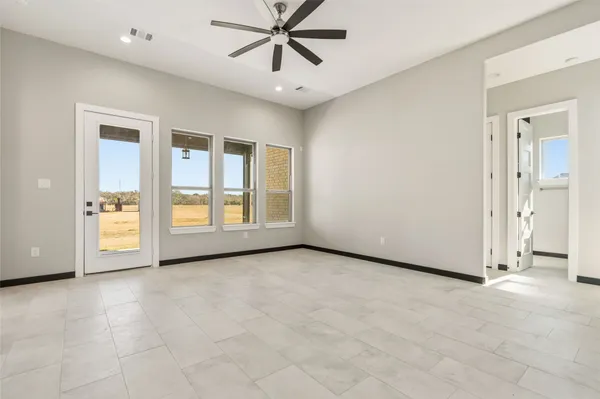 a view of a livingroom with a ceiling fan and window