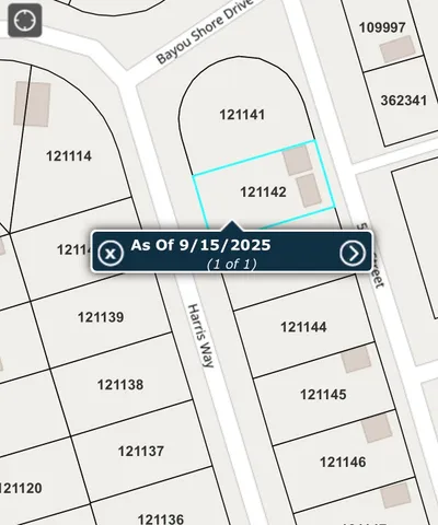 a view of a chair and table in front of house