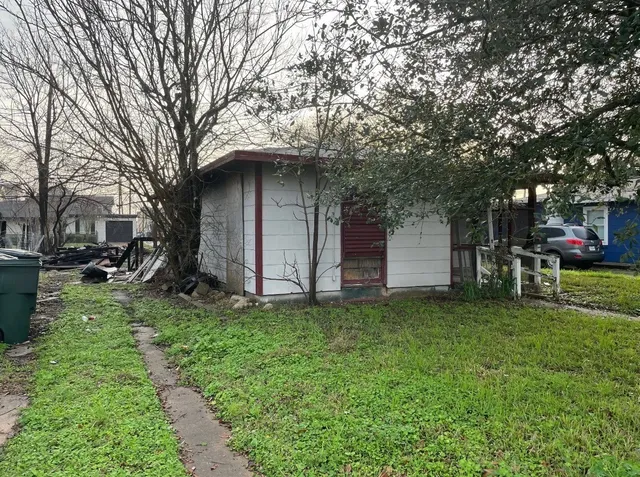 a view of a chair and table in front of house