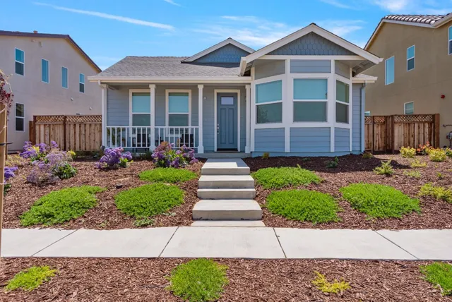 a front view of a house with garden