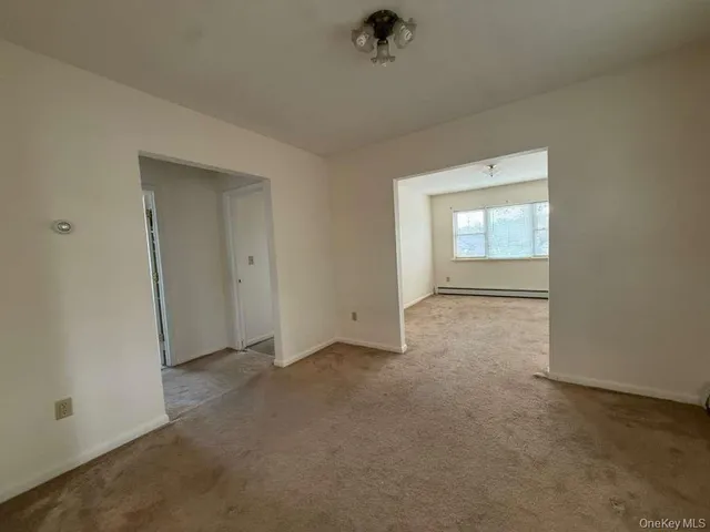 an empty room with a empty space and windows