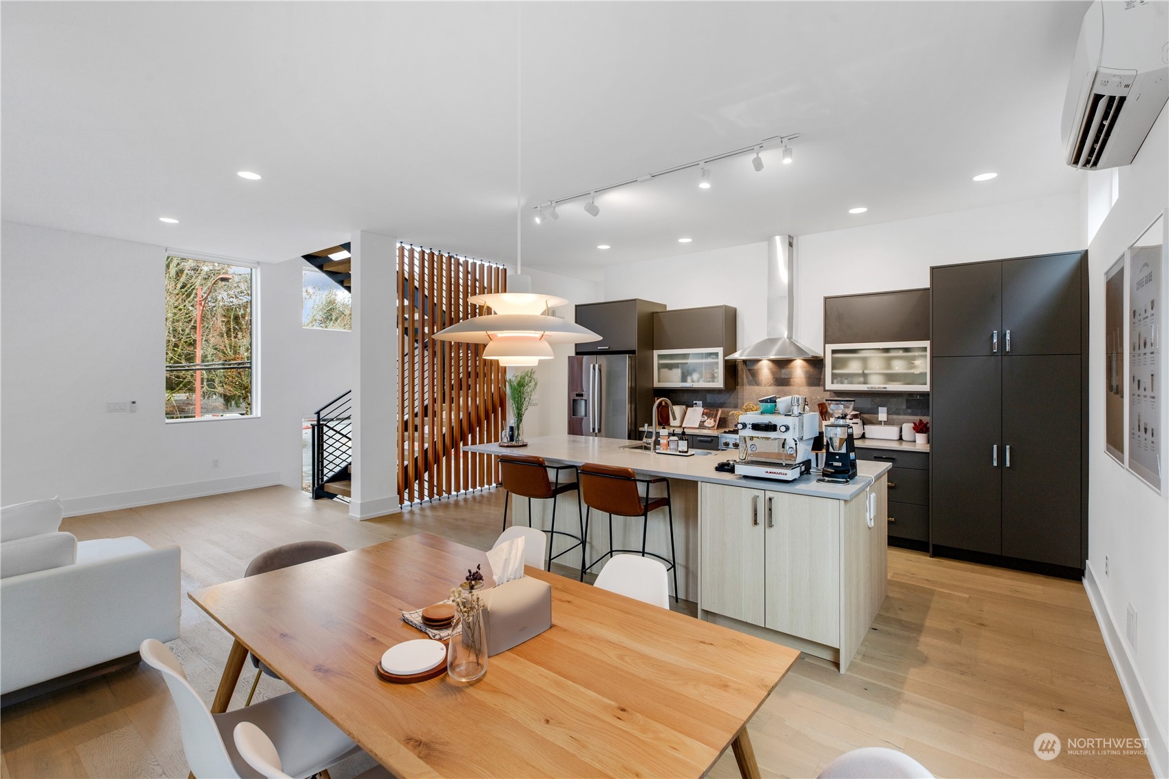 375 3rd Place Northwest Issaquah, WA 98027 - Photo 4 of 24 a kitchen with stainless steel appliances kitchen island granite countertop a table chairs and a refrigerator