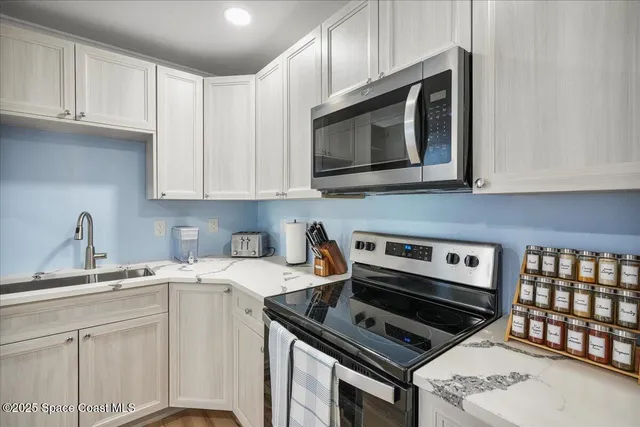 a bedroom with a large bed a flat tv screen and dresser