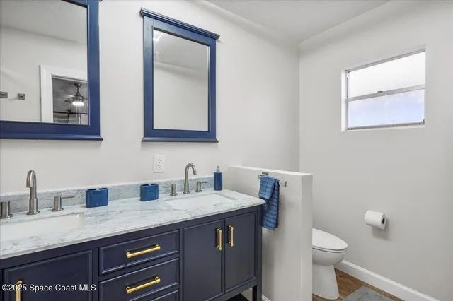 a bathroom with a sink toilet a shower and a mirror