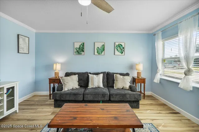 a bedroom with two beds and painting on the wall