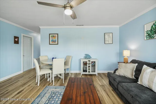a kitchen with a refrigerator a dining table and chairs
