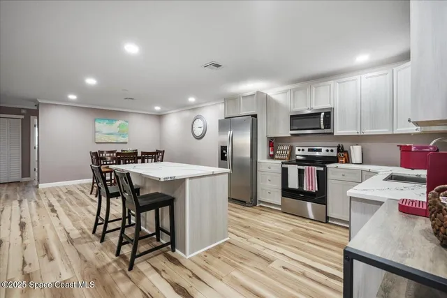 a kitchen with a sink cabinets and appliances