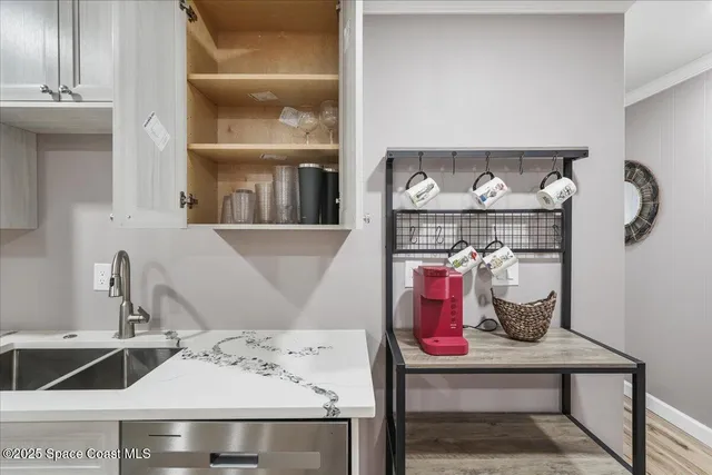 a kitchen with a sink stainless steel appliances and cabinets