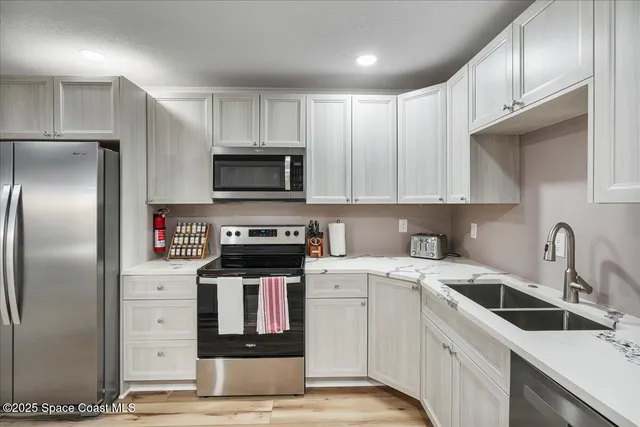 a kitchen with stainless steel appliances kitchen island granite countertop a sink and cabinets