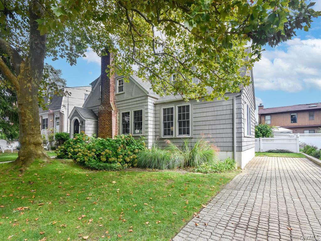 20 Oldwood Road South, Unit 1 Port Washington, NY 11050 - Photo 1 of 20 a front view of a house with garden