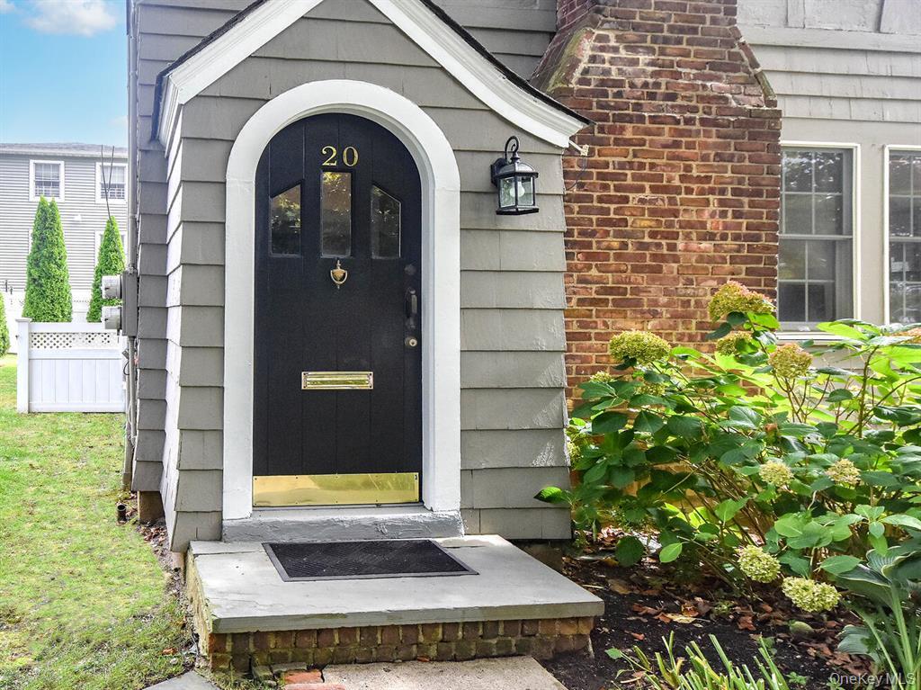 20 Oldwood Road South, Unit 1 Port Washington, NY 11050 - Photo 2 of 20 a front view of a house with garden