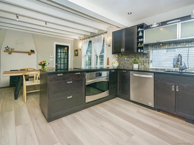 a kitchen with stainless steel appliances granite countertop a stove a sink dishwasher and a refrigerator