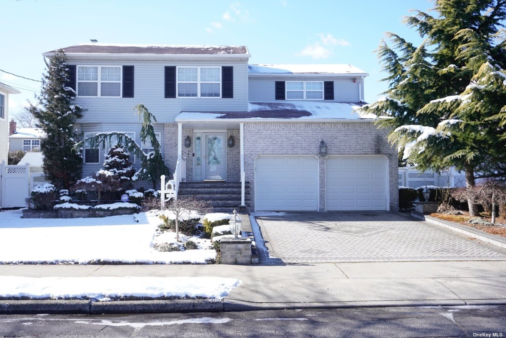 2150 Beech Street Wantagh, NY 11793 - Photo 1 of 1 a front view of a house with lots of yellow lighting