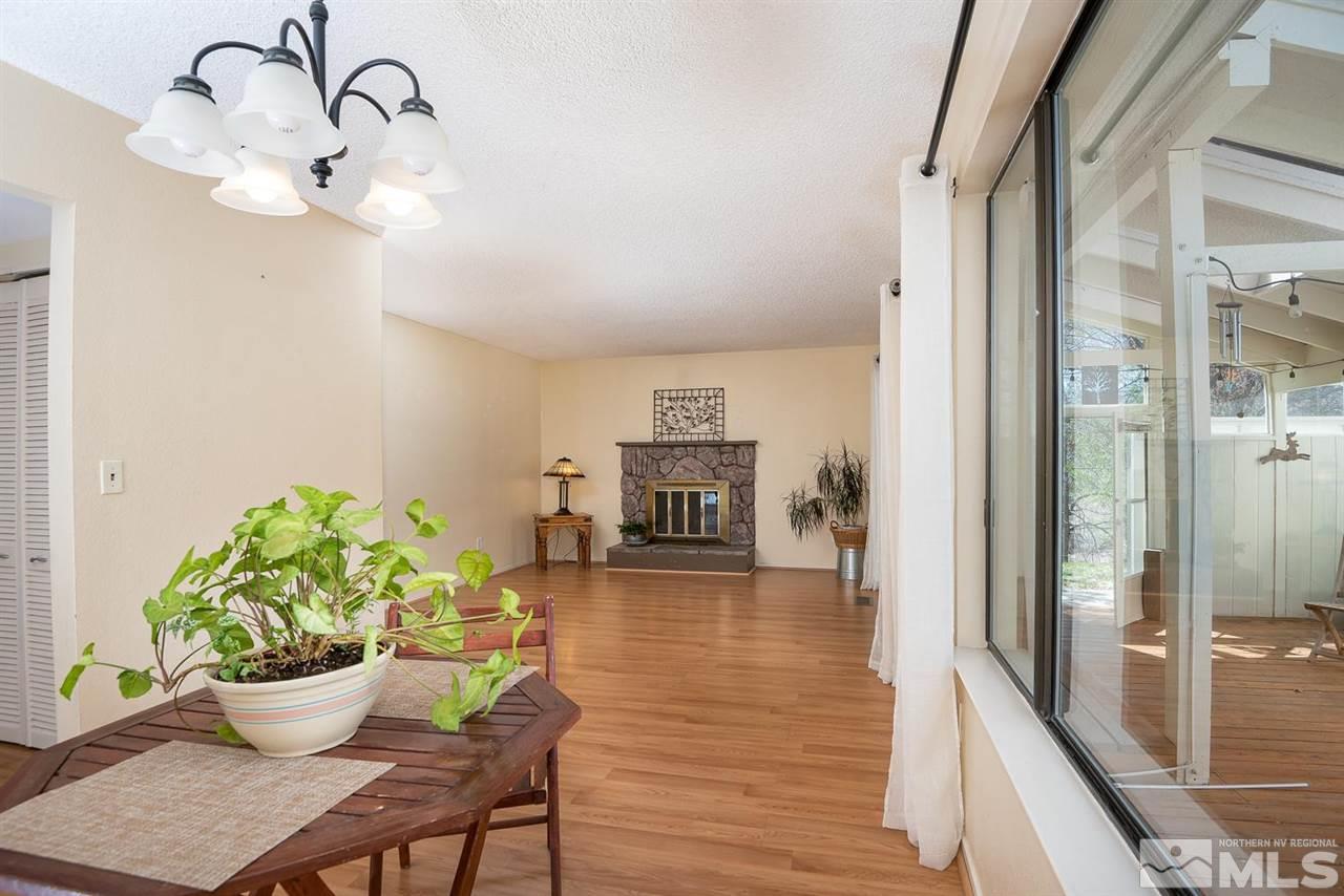 1235 Conway Lane Reno, NV 89503 - Photo 11 of 37 a dining room with furniture a potted plant and wooden floor