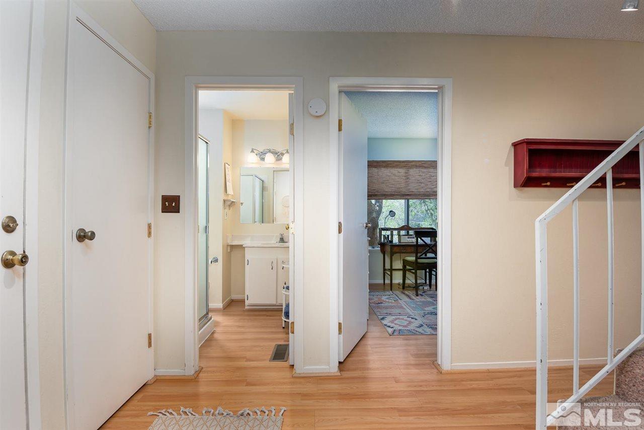 1235 Conway Lane Reno, NV 89503 - Photo 15 of 37 a view of a hallway with wooden floor and a bathroom