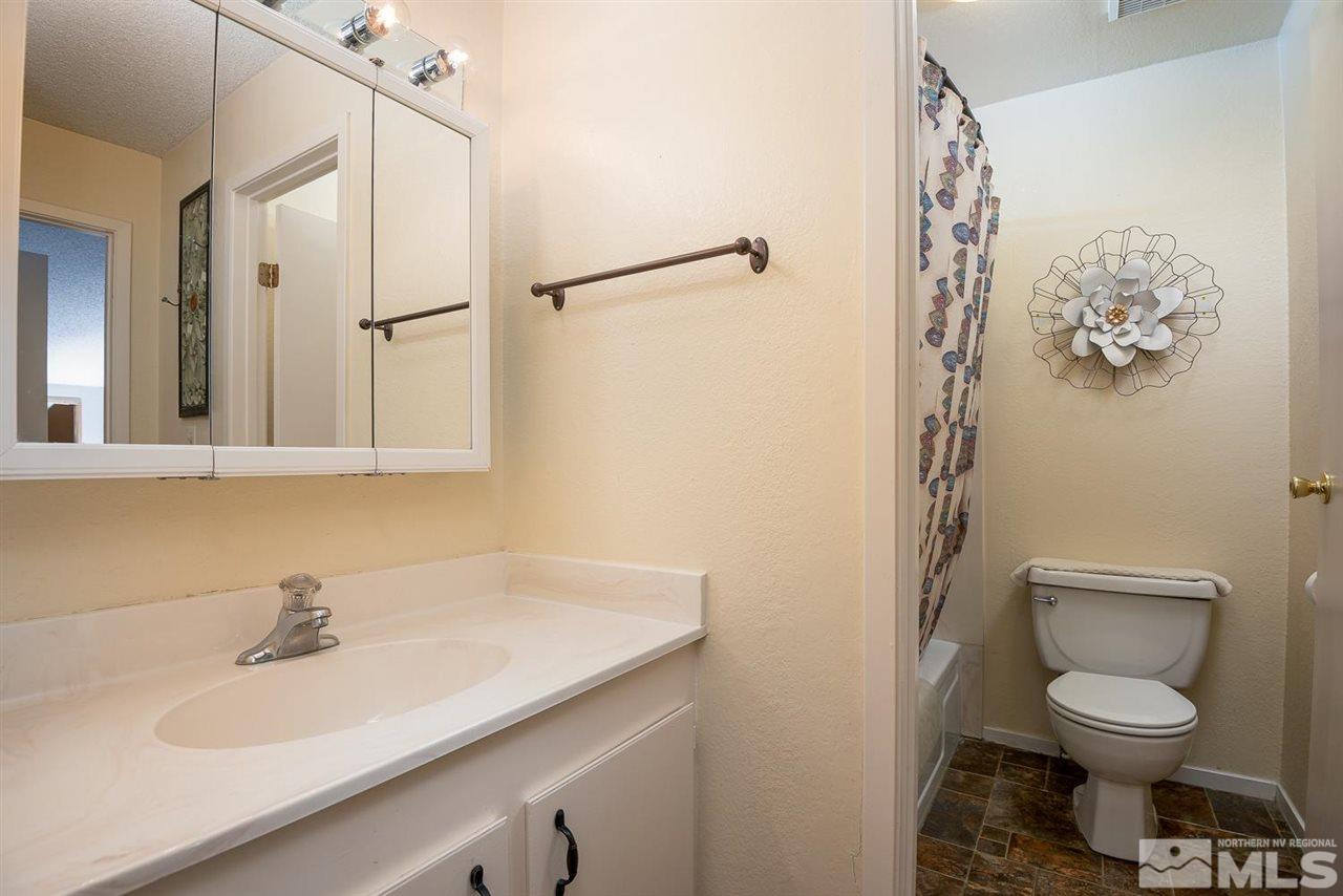 1235 Conway Lane Reno, NV 89503 - Photo 16 of 37 a bathroom with a sink a toilet and shower