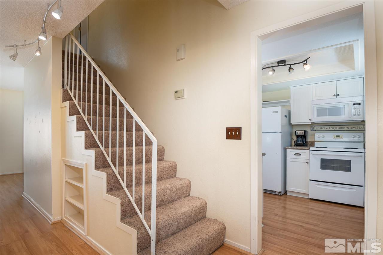 1235 Conway Lane Reno, NV 89503 - Photo 21 of 37 a view of kitchen and hallway with wooden floor