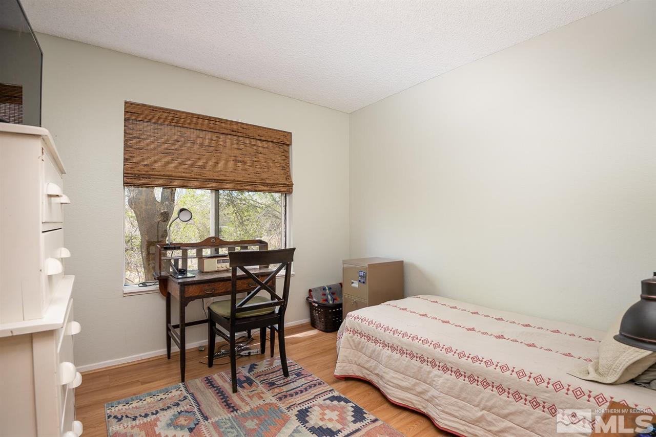 1235 Conway Lane Reno, NV 89503 - Photo 22 of 37 a bedroom with a bed and a table