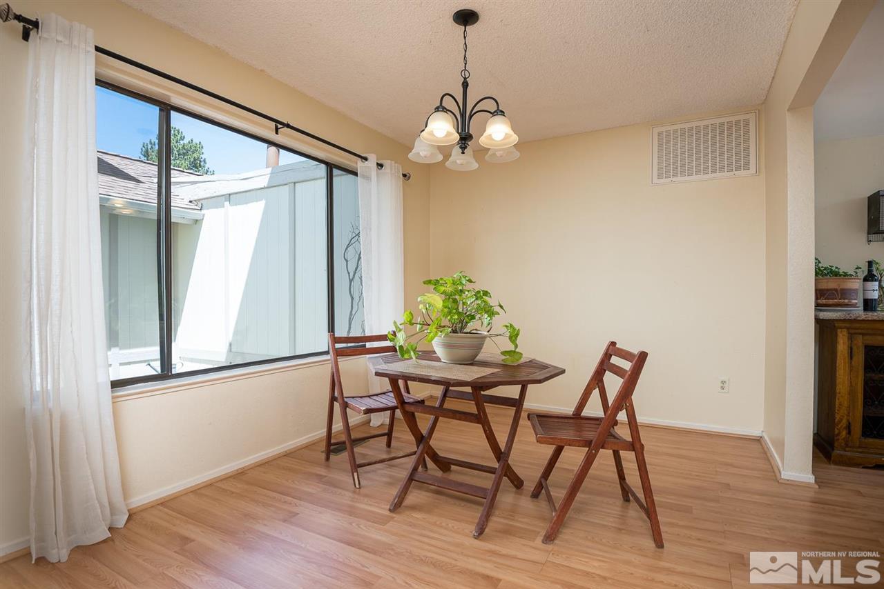 1235 Conway Lane Reno, NV 89503 - Photo 9 of 37 a view of a dining room with furniture window and wooden floor