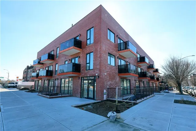 a view of a brick building with many windows