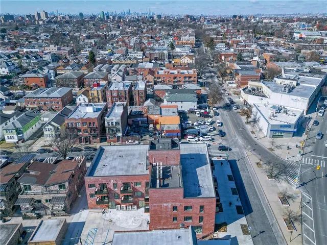 an aerial view of a house with a swimming pool outdoor seating and yard