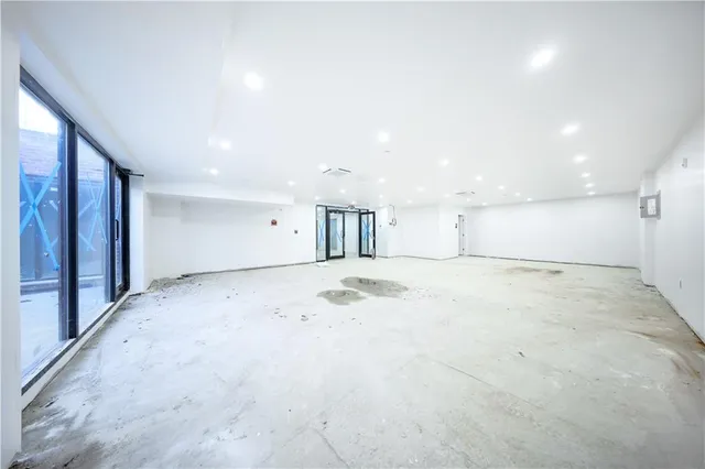 an empty room with a empty space and windows