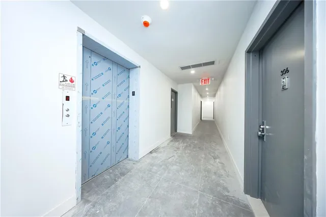 a kitchen with cabinets a refrigerator and a sink