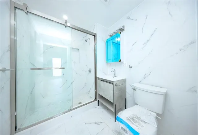 a large kitchen with stainless steel appliances granite countertop a stove a sink and a large window