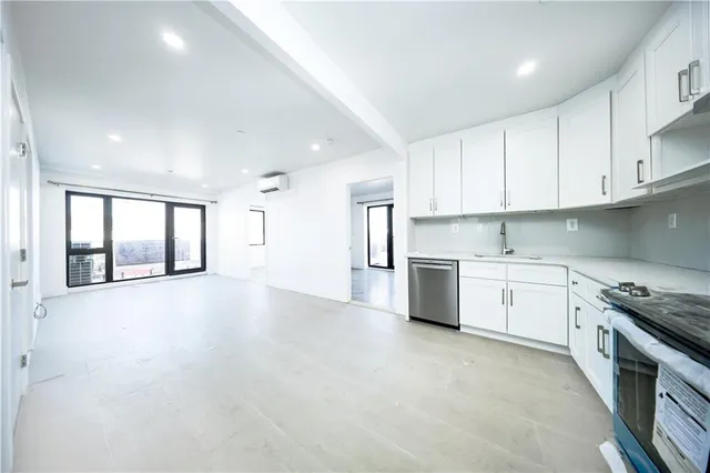 a view of a kitchen with a stove cabinets and a kitchen