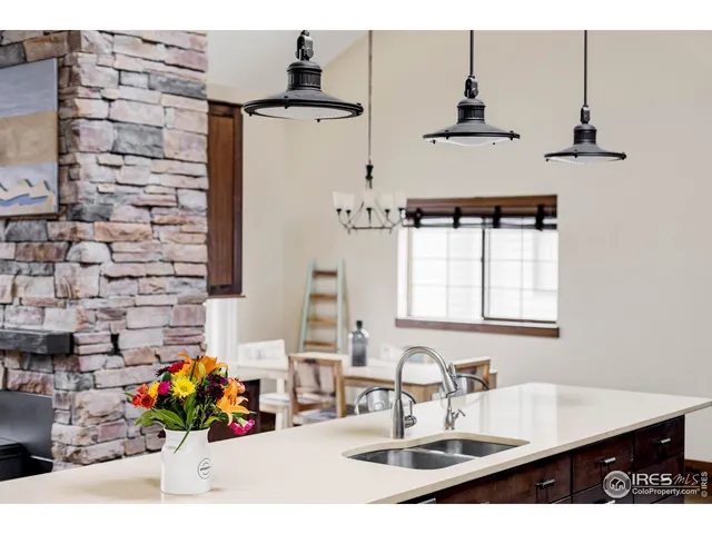 a kitchen with sink a microwave and cabinets