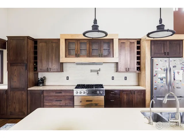 a kitchen with kitchen island a stove a table and chairs