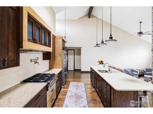a kitchen with stainless steel appliances a cabinets and a stove top oven
