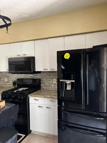 a kitchen with a refrigerator and a stove