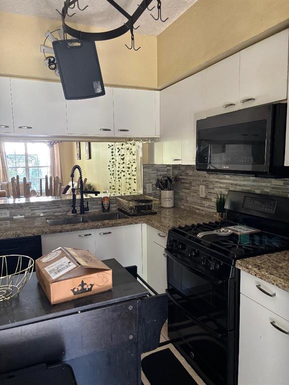 11050 Conch Court Tamarac, FL 33321 - Photo 12 of 17 a kitchen with a stove a sink and a microwave